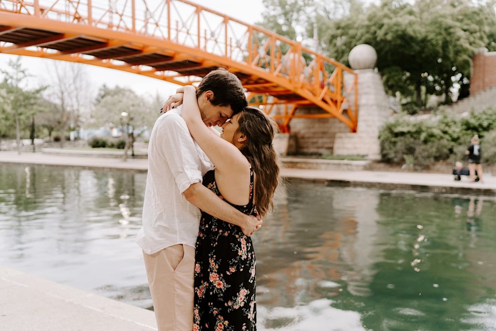 Couple pose at Canal walk in Indiana, one of their engagement session locations