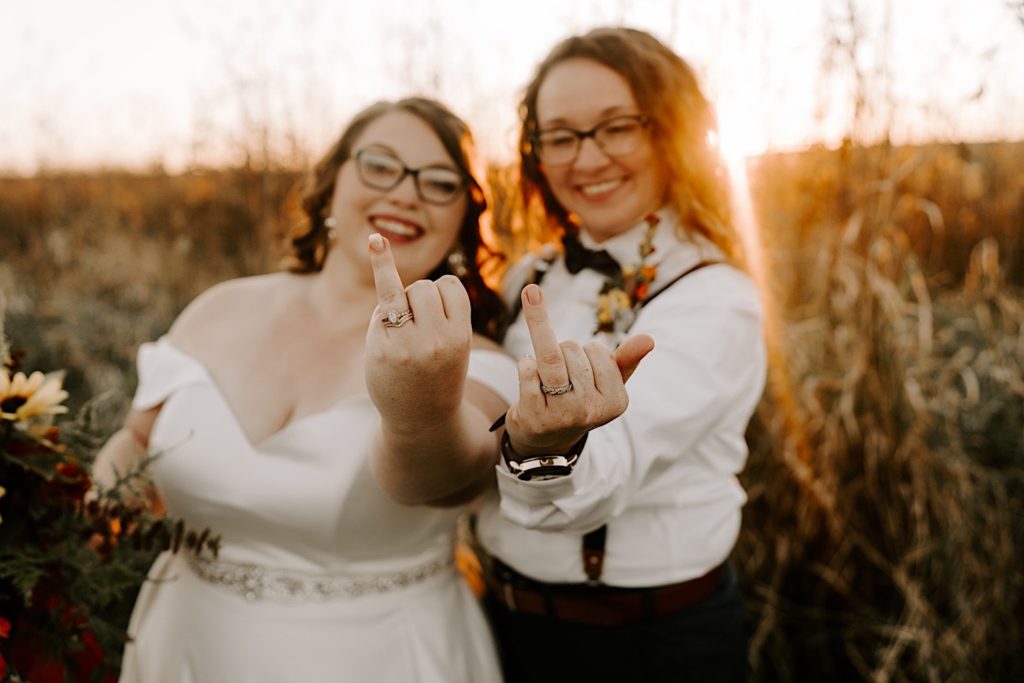 Newlywed brides show off their wedding rings in the sunset