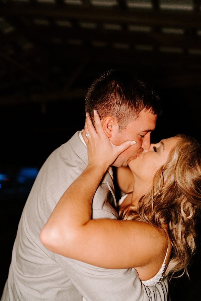 Newlyweds kissing after reception ends