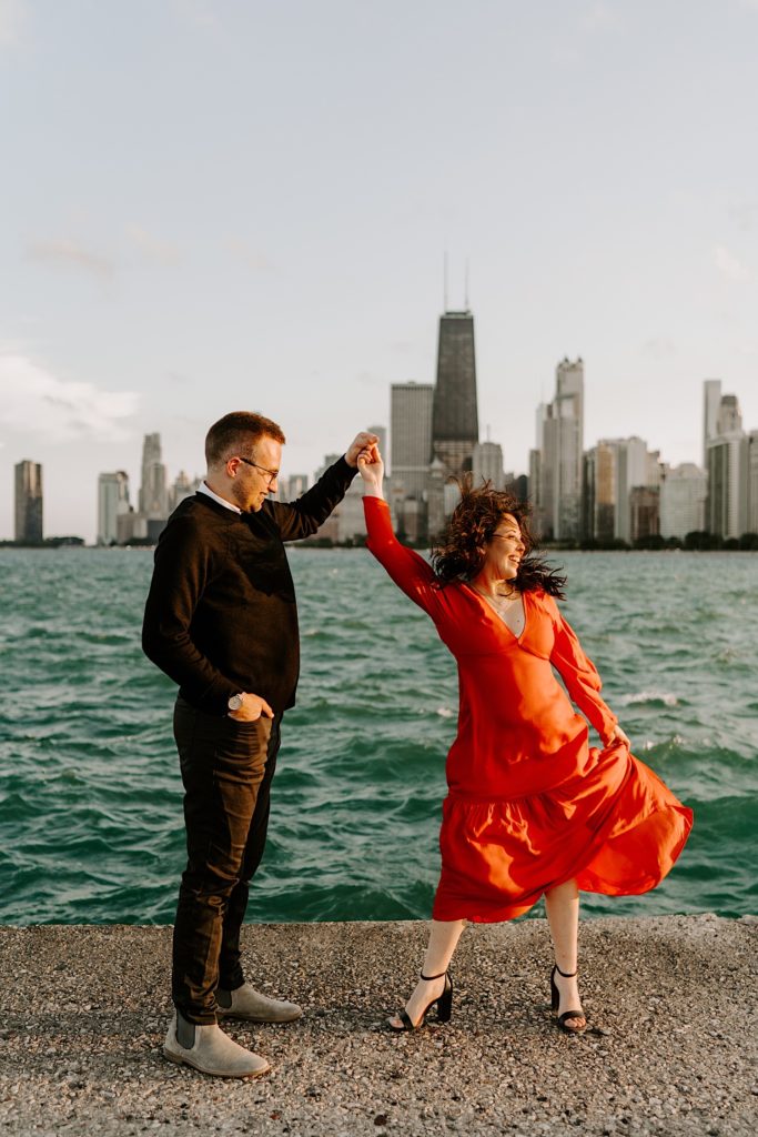Couple dances together in front of Lake Michigan and the Chicago skyline at North Avenue Beach