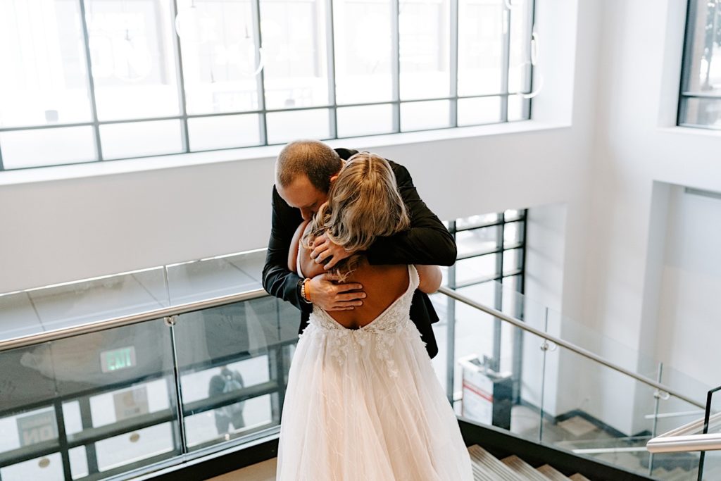 Bride and groom embracing after first look in Downtown Indianapolis 