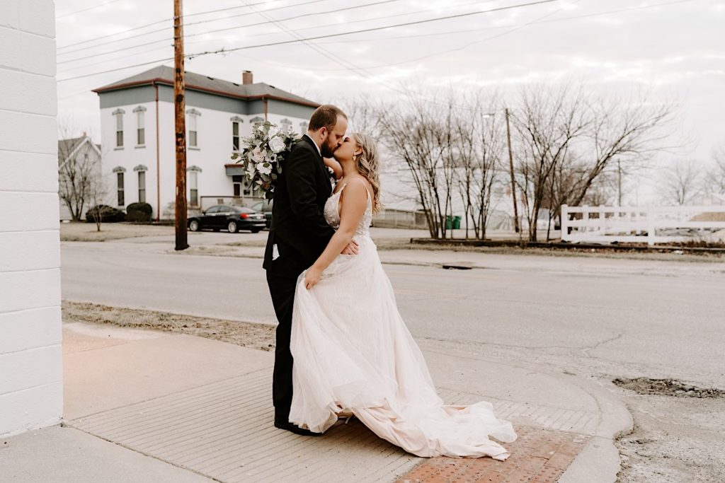 Newlyweds kiss in front of street in downtown Indianapolis