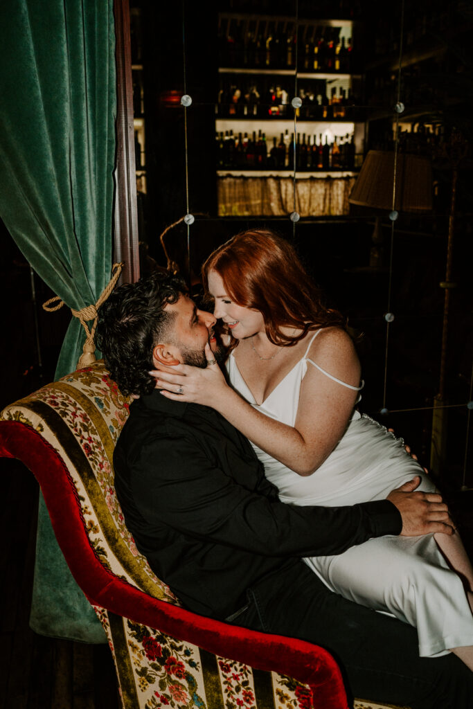 A couple kisses while taking engagement photos at salvage one.