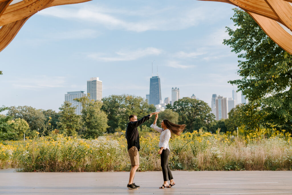 A couple dances overlooking the Chicago skyline at the Lincoln Park Nature Walk under the honeycomb.