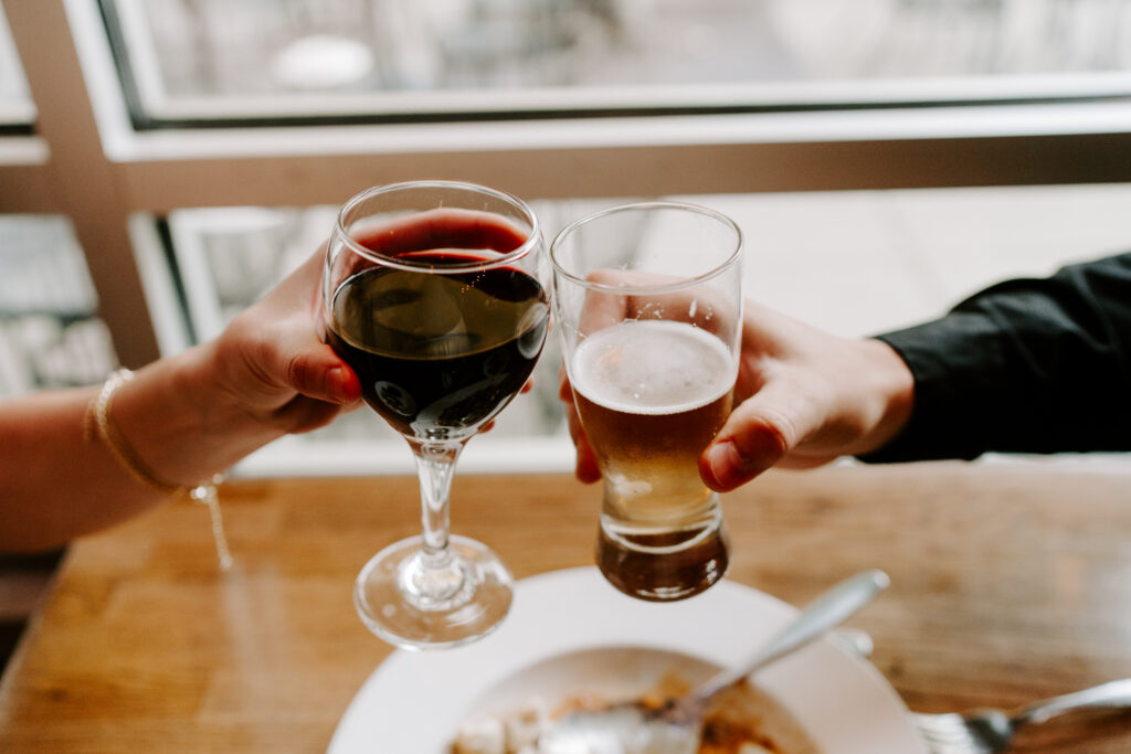 An engaged couple shares libations at a Chicago restaurant during their engagement session.