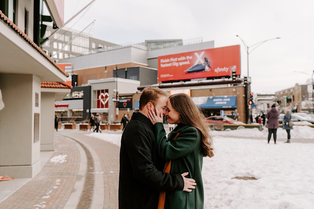 Couple pauses for an intimate moment outside of Wrigley field for their winter engagement session.  