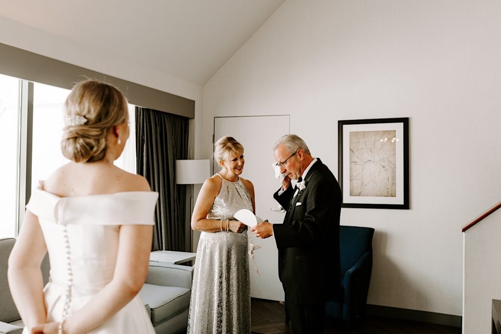 Bride shares a letter with her parents the morning of her wedding in the hotel room before the ceremony.