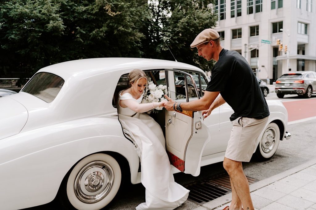 Bride arrives at Indiana Repertory Theatre in a 56 Rolls Royce for her first look with her future husband