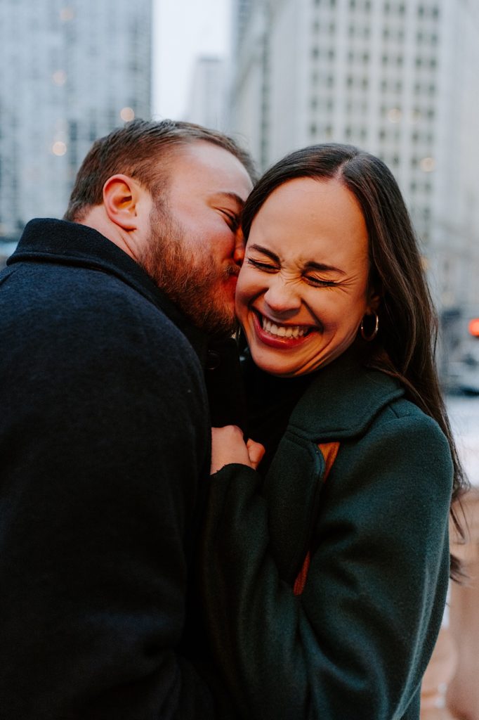 Couple kisses during winter engagement session.
