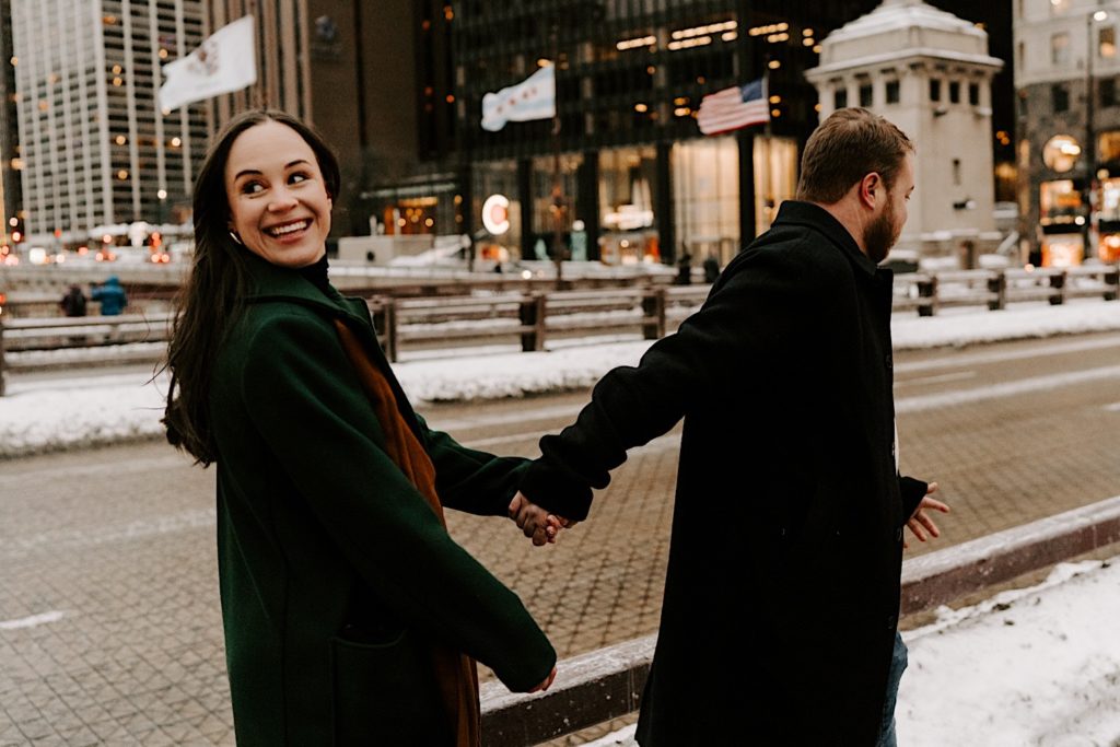 Couple walks through Chicago during their winter engagement session.