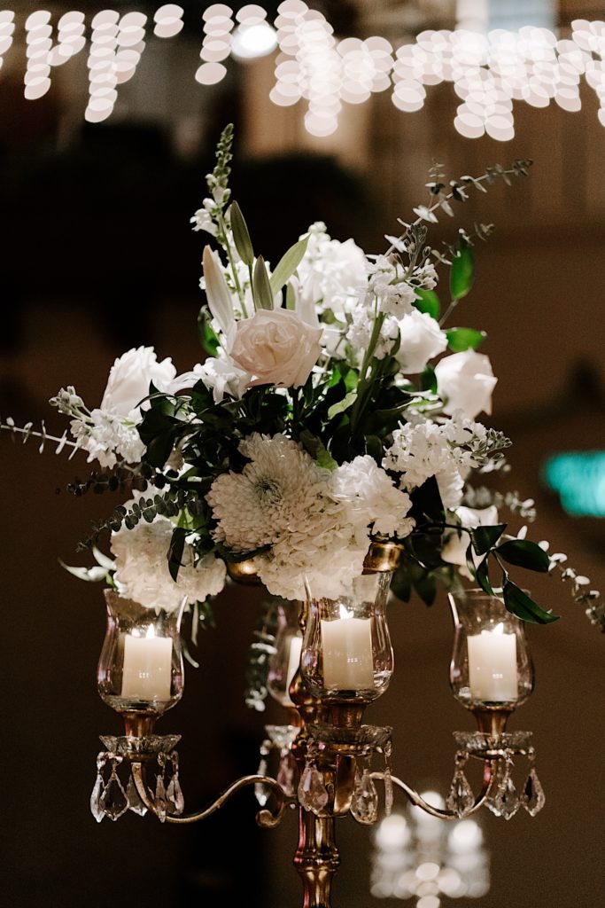 Ivory flowers sitting over a candelabra  as decorations for a wedding in Indianapolis