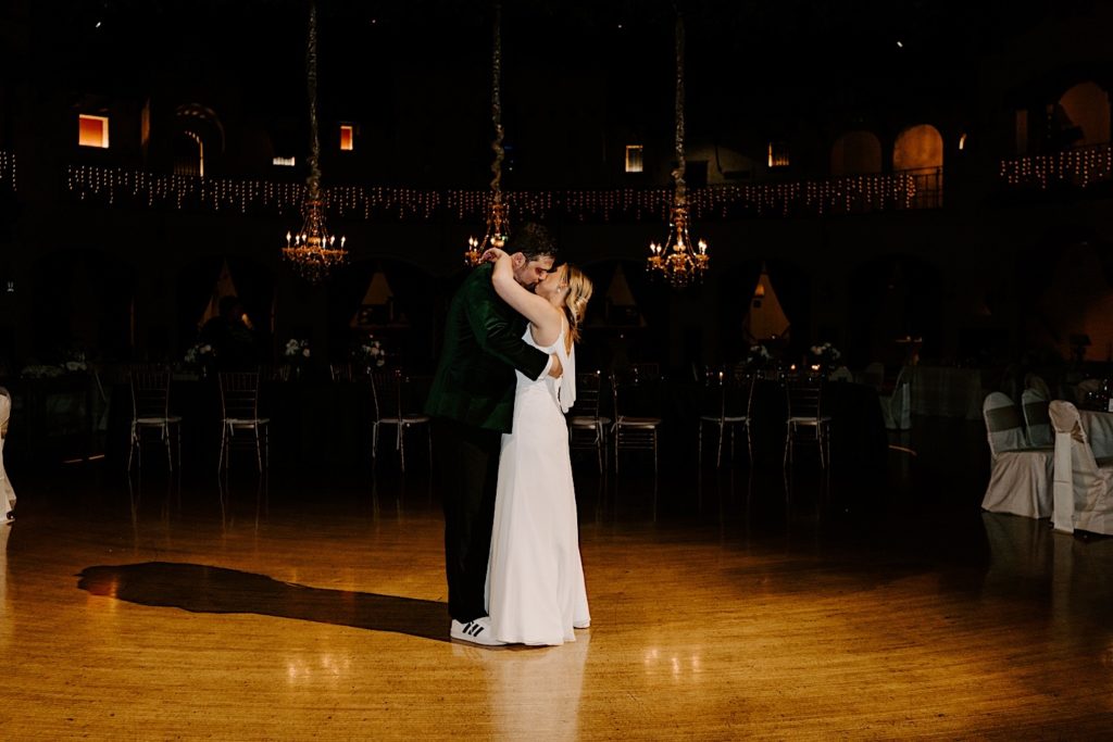 Bride and groom share a kiss while having their last dance in an empty wedding venue in Indianapolis.