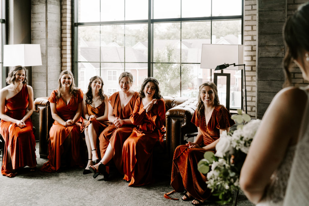 Bride has a first look with her bridesmaids in their Chicago Airbnb.