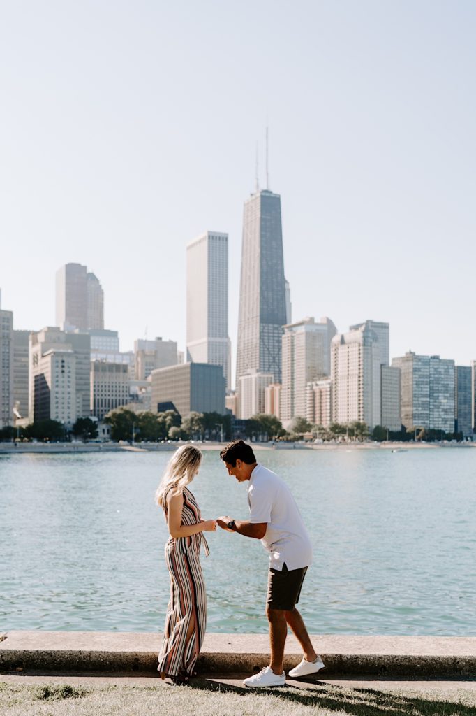Man proposes to his girlfriend on a summer day at Milton Lee Olive Park.