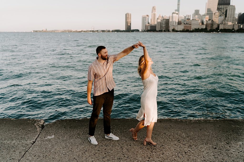 An engaged couple dances on the ribbon at North Avenue Beach in Chicago