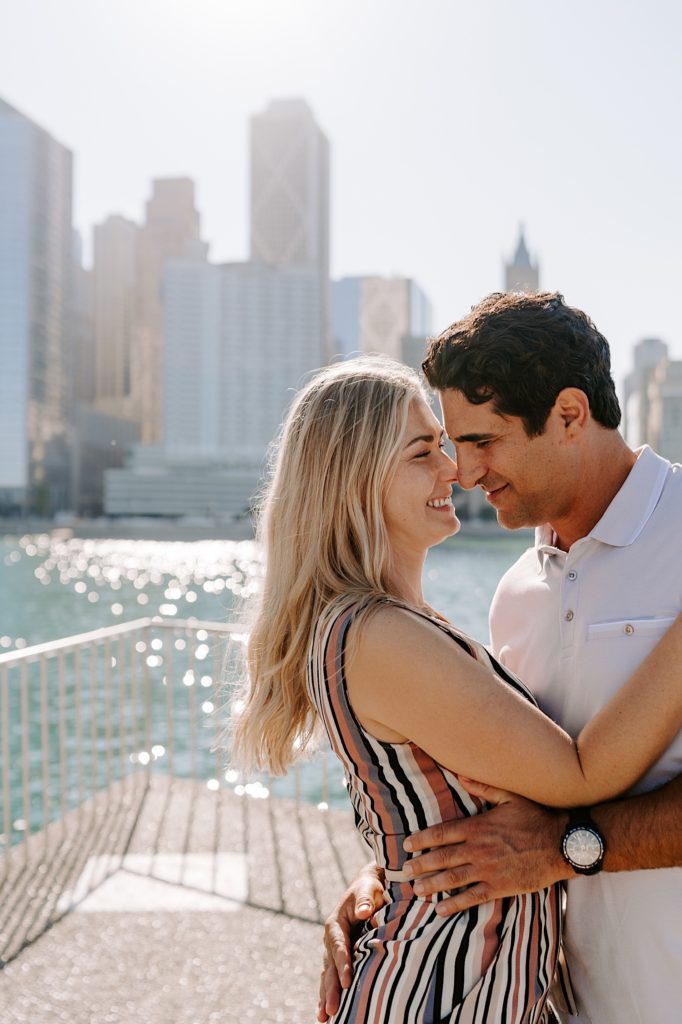 Fiancés dance the lake front in Chicago just after their surprise proposal at Milton Lee Olive Park