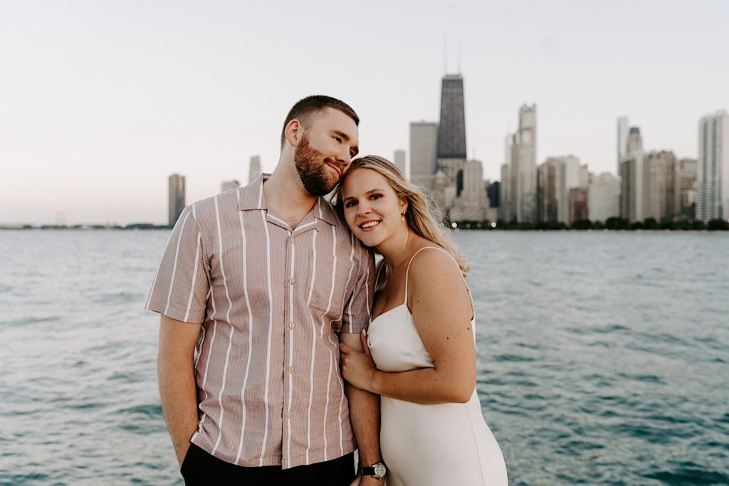 A couple smiles and looks at the camera during their engagement session with their Chicago wedding photographer