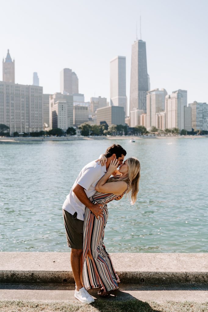 Fiancees kiss during after proposing on the lake front in Chicago