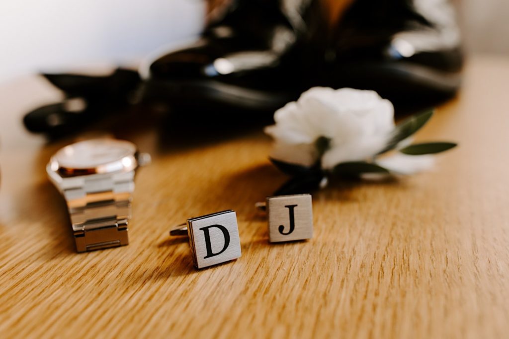 A married couples initials on wedding cufflinks.