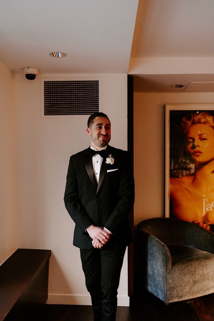 A groom sees his bride for the first time the morning of their morning in their Chicago hotel.