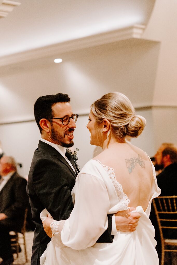 A bride and groom share their first dance at their wedding reception