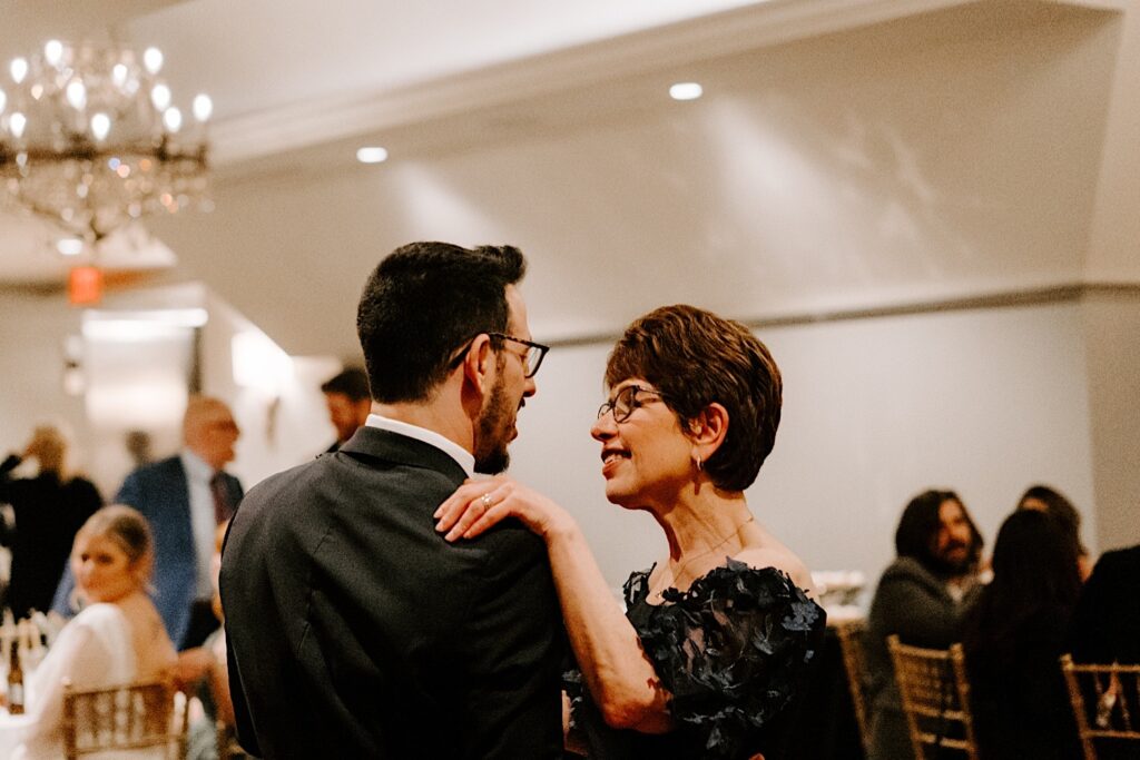 A groom and his mother share their first dance together at his wedding reception at Barrington's White House.