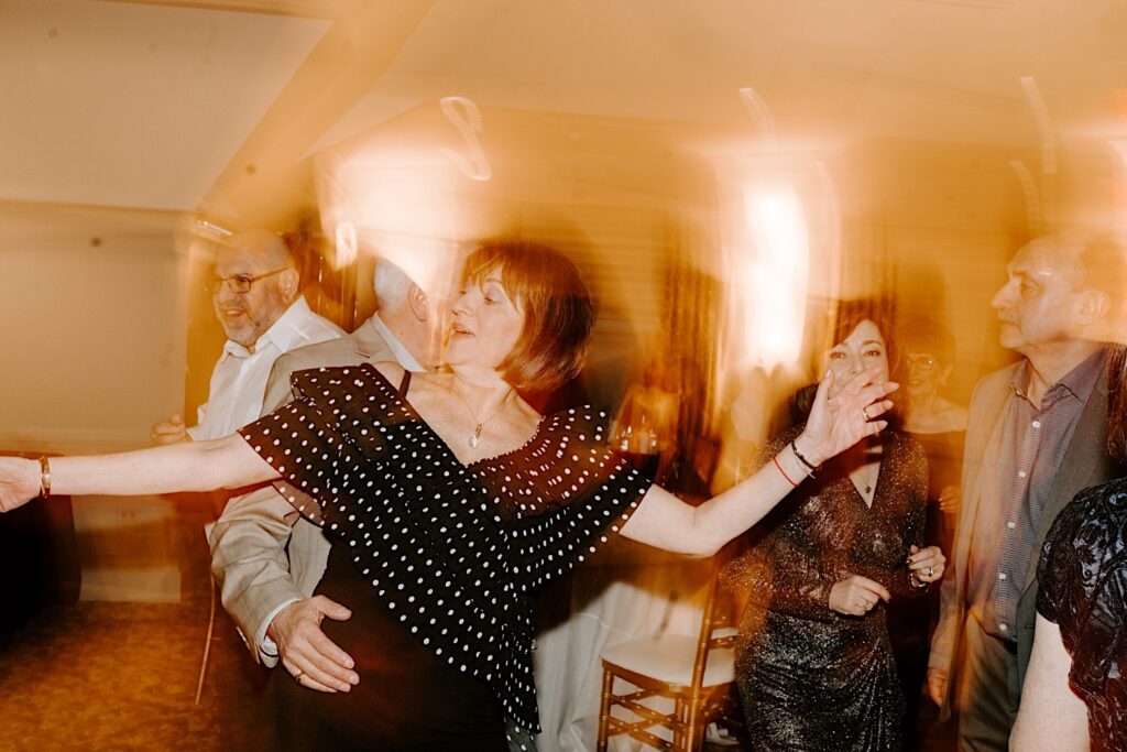 Guests of a wedding dancing together with a lighting effect.