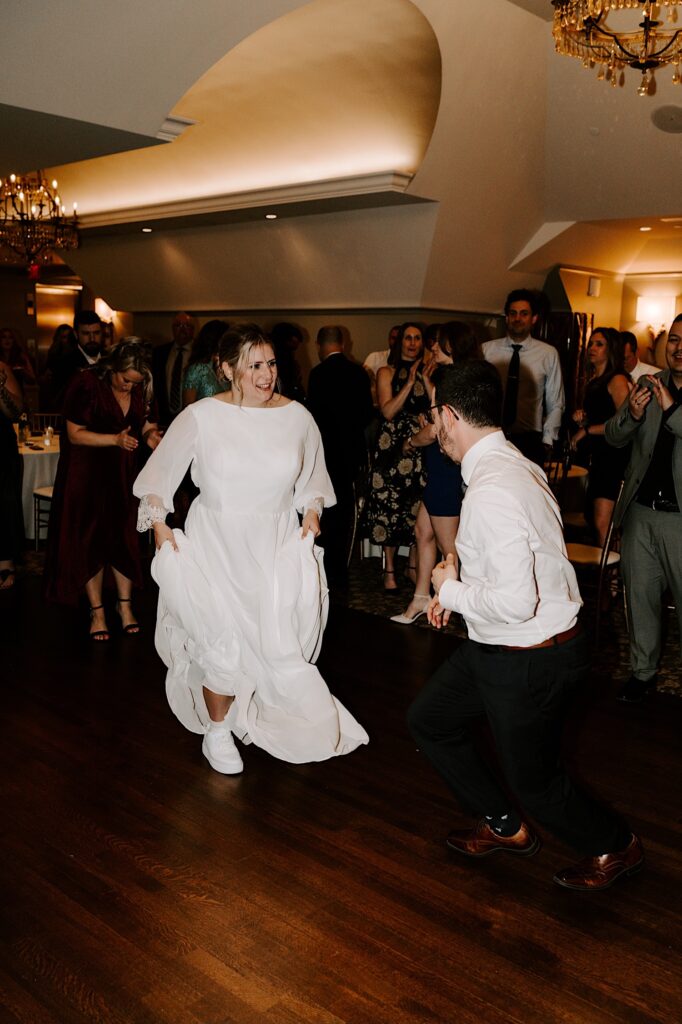 A bride and groom dance together during their wedding reception.