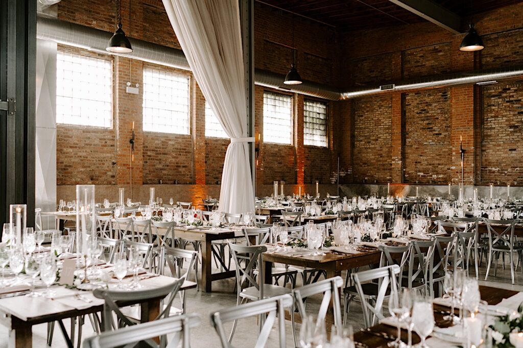 An indoor space of a brick building decorated for a wedding reception