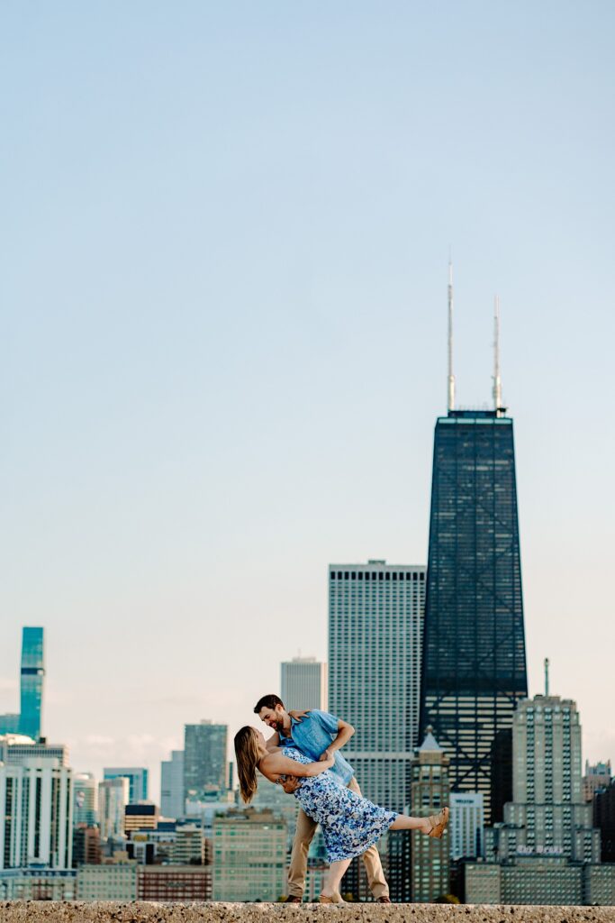 A man and woman dance together with the Chicago skyline in the background
