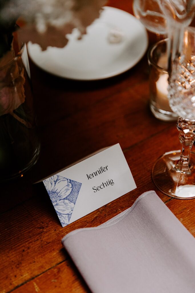 A nametag rests on a table for a wedding reception
