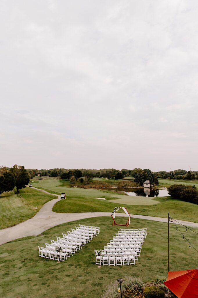 An outdoor wedding ceremony space set up on the grounds of the Makray Golf Club looking out over the golf course