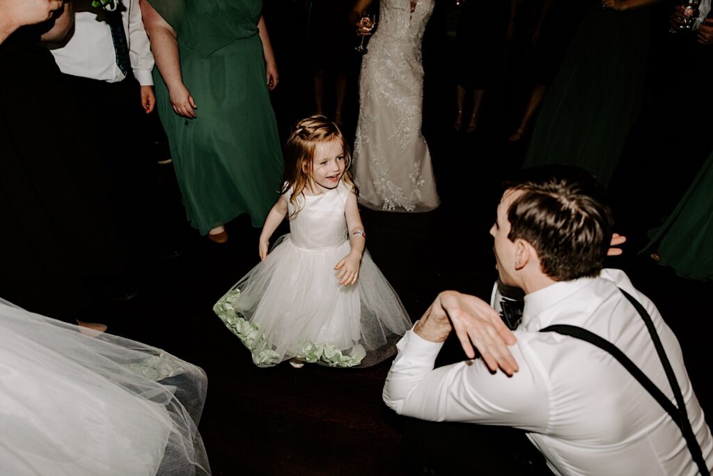 A flower girl dances in a dance circle during an indoor wedding reception at the Makray Golf Club in the Chicagoland area