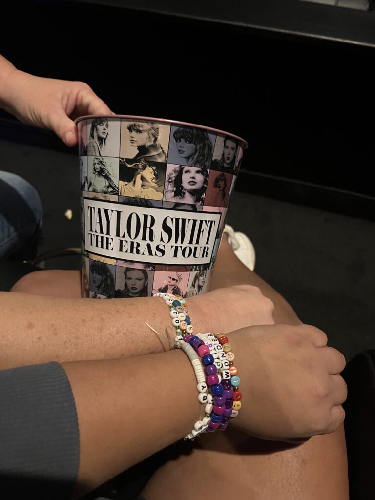 An image of someone holding a popcorn bucket for Taylor Swift's eras tour