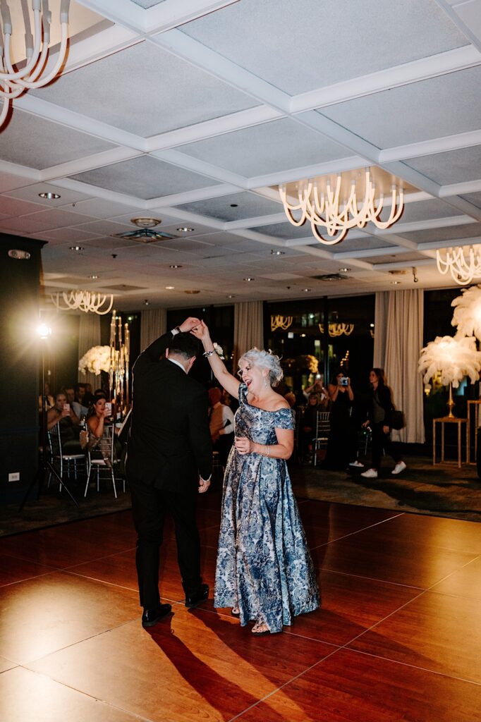 A groom and his mother dance together during a reception at the Voco Hotel in Chicago