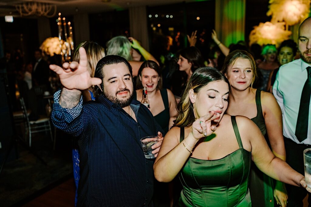 Bridesmaids and other guests of a wedding all dance together during a reception at the Voco Hotel in Chicago