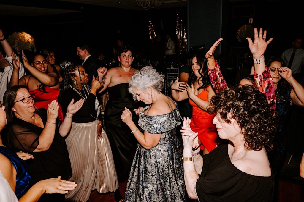Guests of an indoor wedding reception at the Voco Hotel in Chicago dance and celebrate together