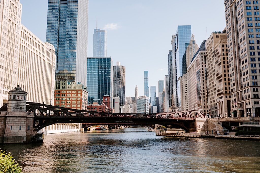A photo of a bridge crossing the Chicago river, with buildings towering all around