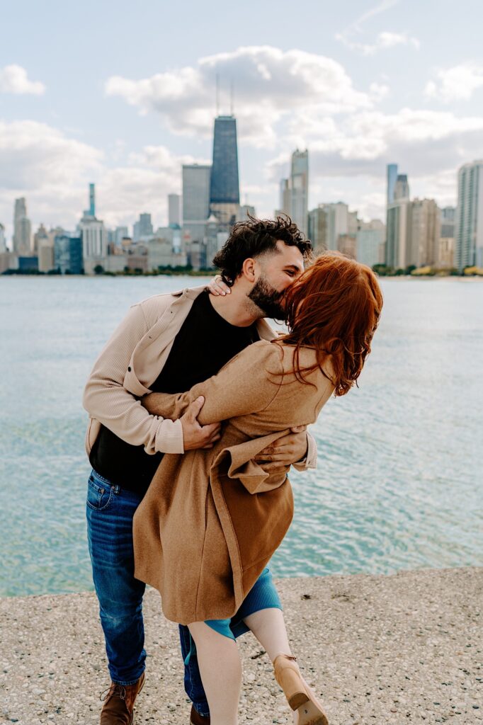 A couple kiss as they dance in front of Lake Michigan and the Chicago skyline