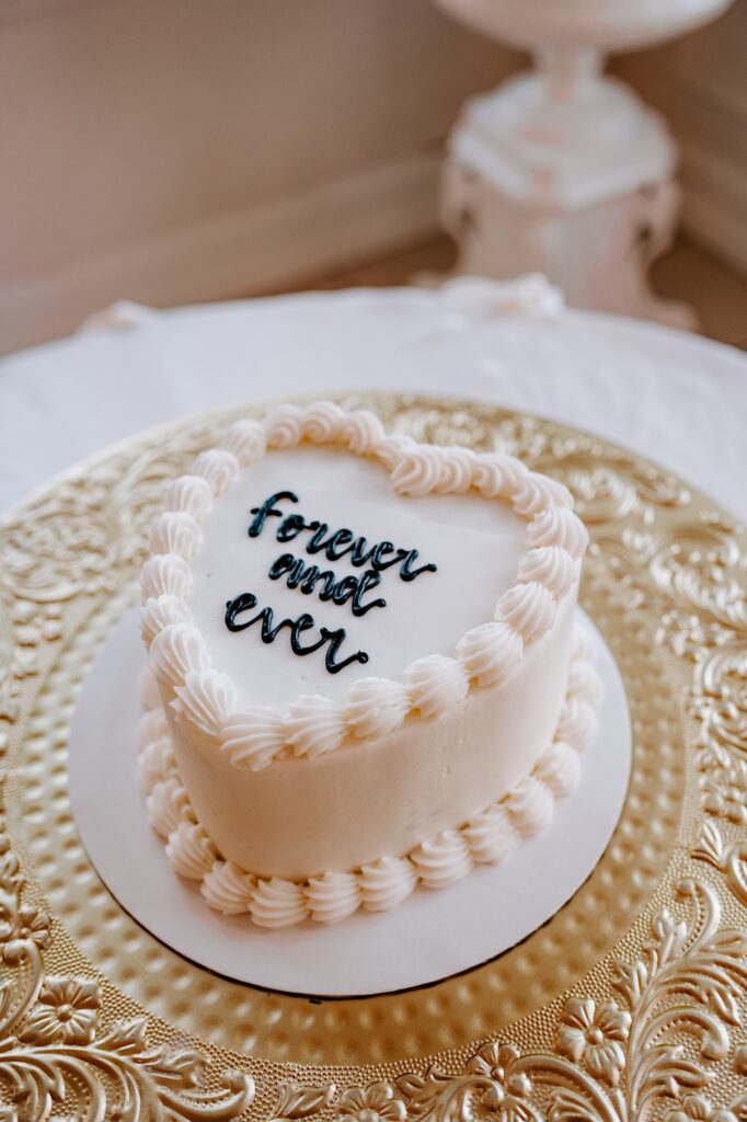 A wedding cake with the words "forever and ever" written on  it in frosting
